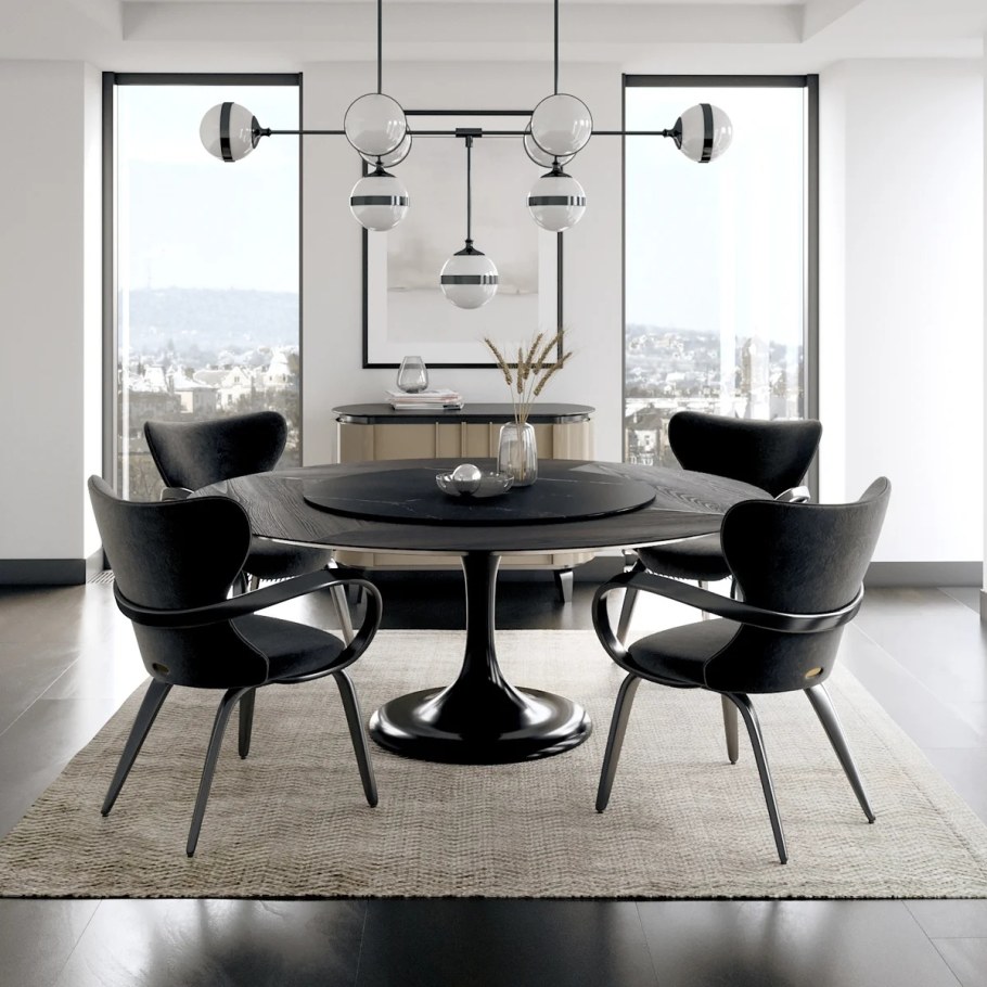 Круглый черный обеденный стол в интерьере