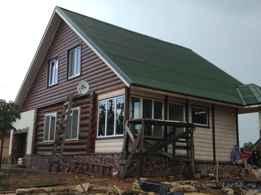 Деревянный дом с зеленой крышей