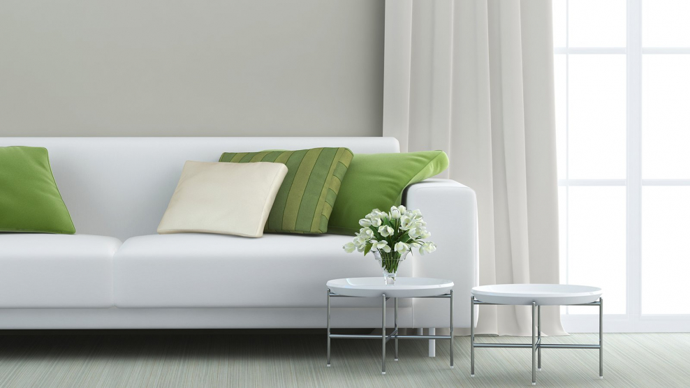 Диван на фоне окна в интерьере