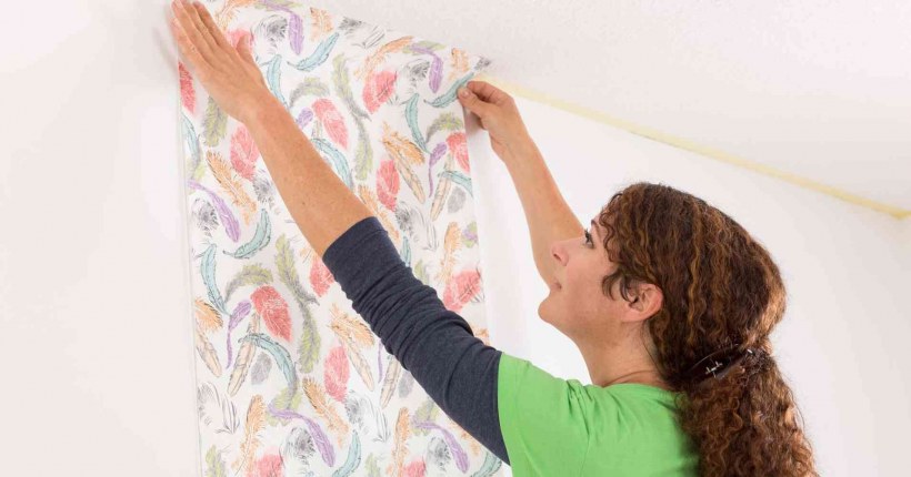 Человек клеит обои