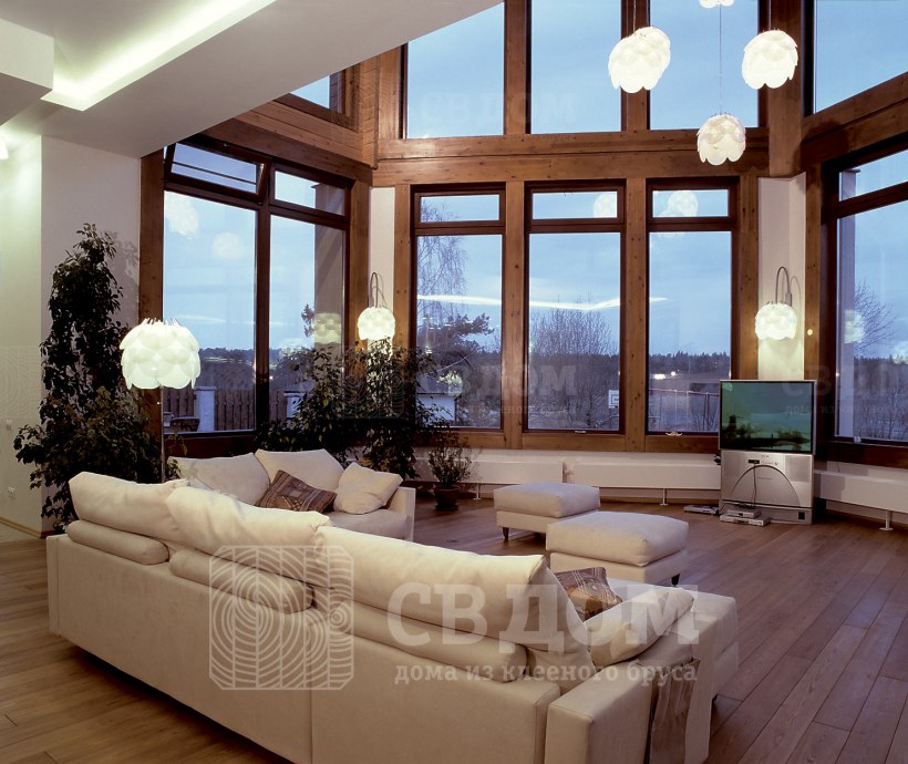 Гостиная с панорамными окнами в частном доме из клееного бруса