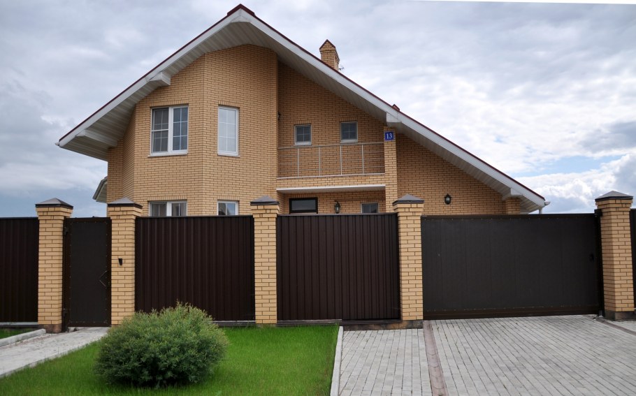 Кирпичный дом с заборо