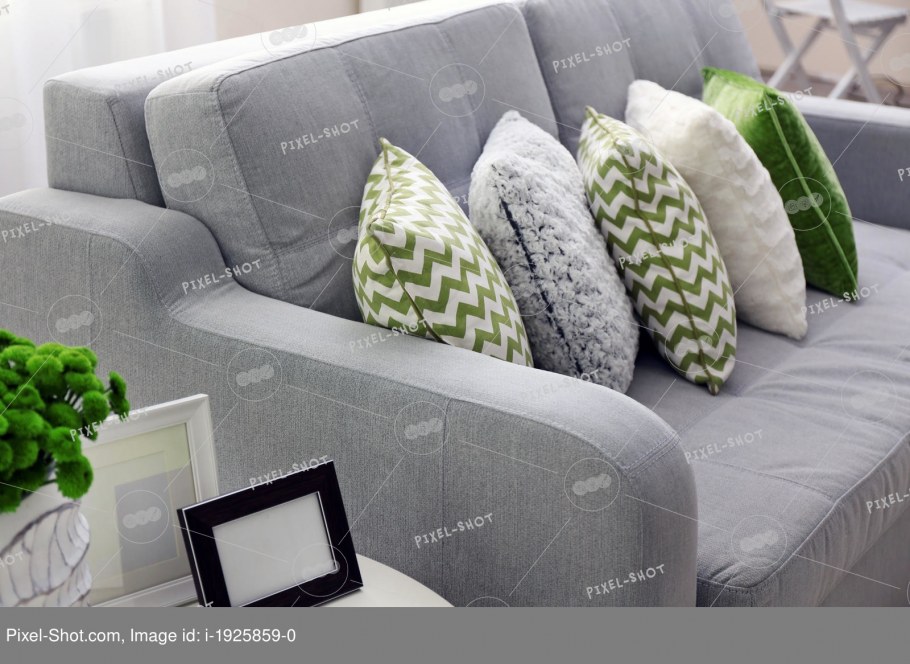 Серый диван с зелеными подушками
