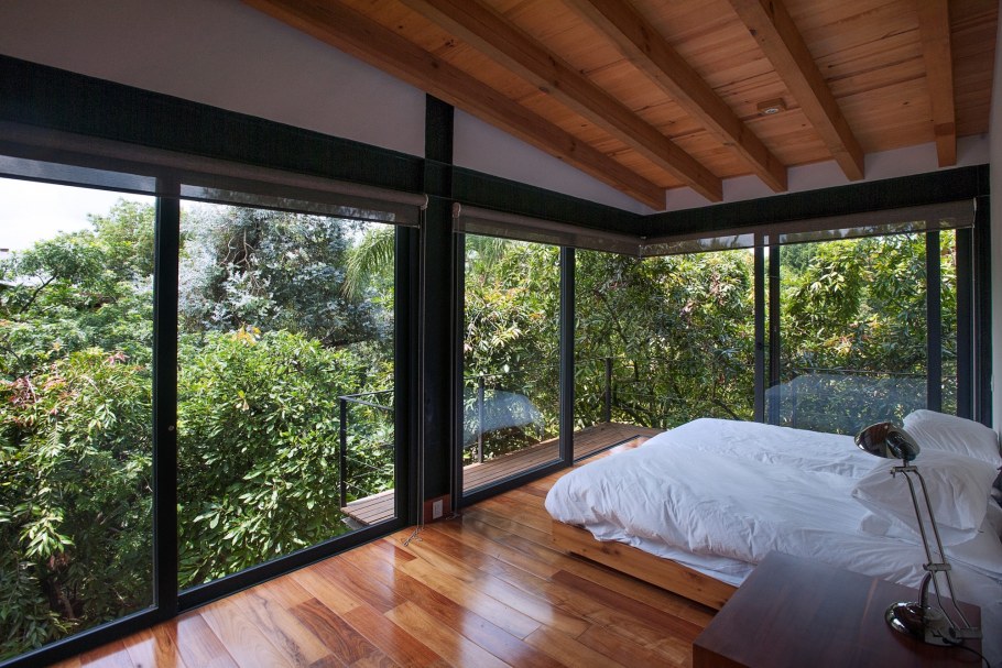 Спальня с панорамным окном в лесу