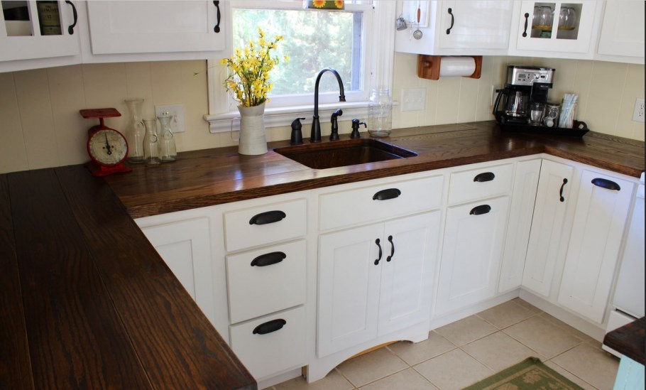 Белая кухня с темной столешницей под дерево